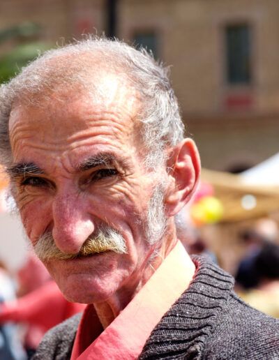 Retrato de un hombre mayor de barba blanca en un mercado de Barcelona