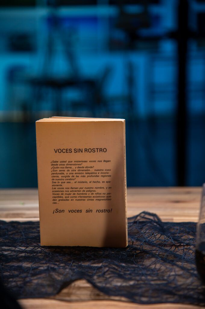 Libro «Voces sin rostro» de pie sobre la mesa del podcast